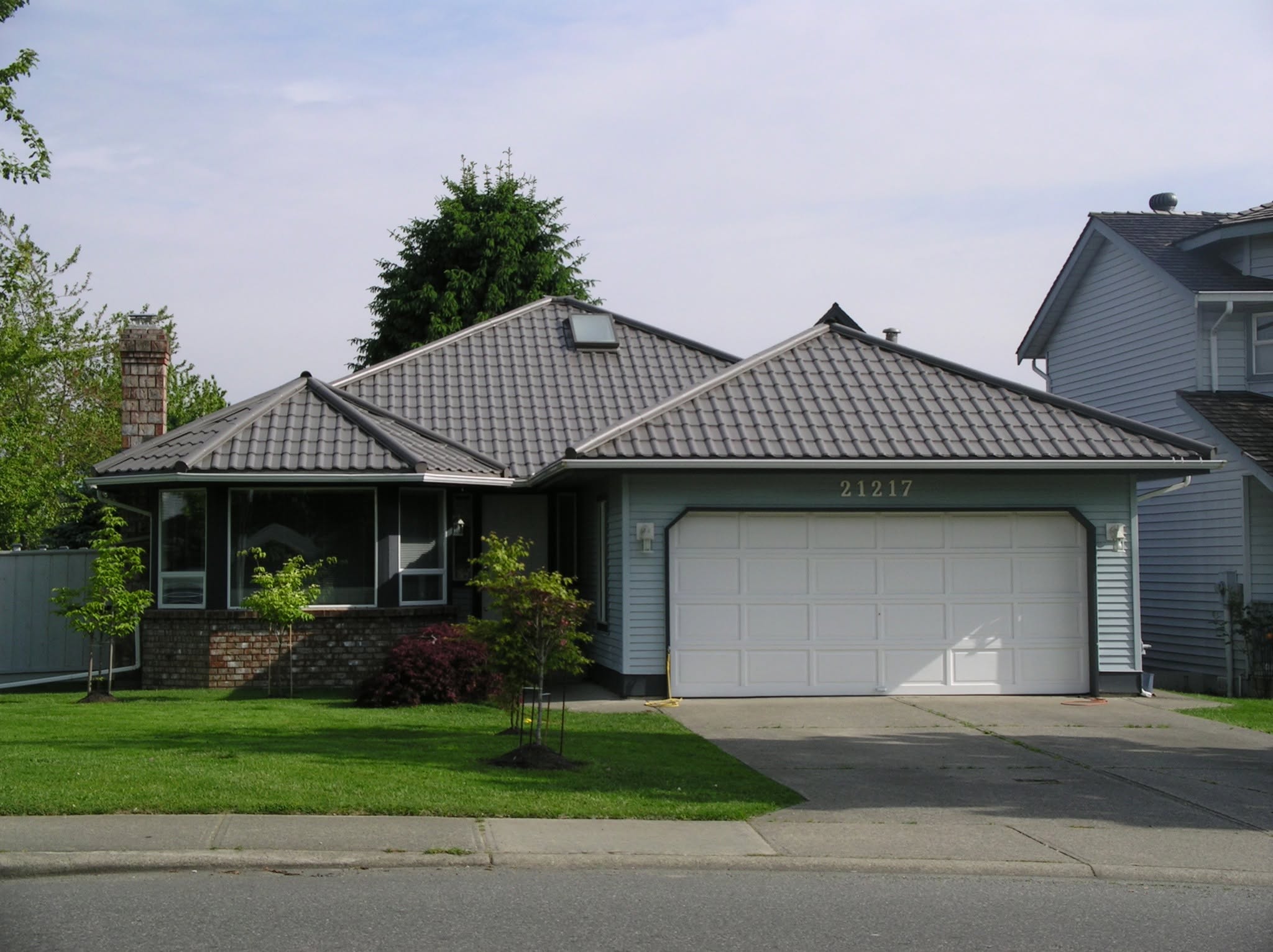 RARE Manufacturing European Tile metal roofing installed on a home